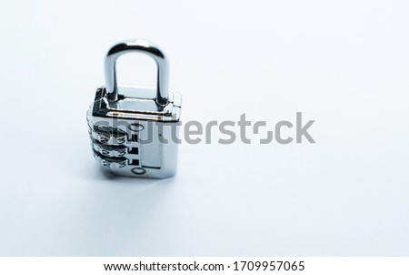 A lock and key on a plain white background. Selective focus, Selective focus on subject, background blur 
