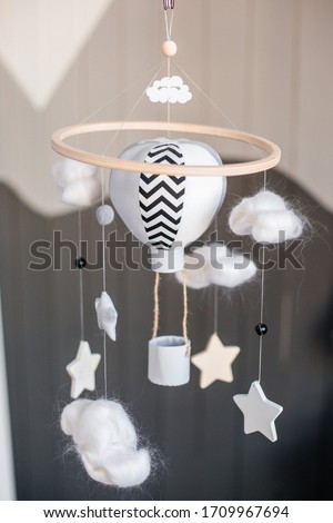 Decoration in a nursery, a balloon, wooden stars and soft clouds