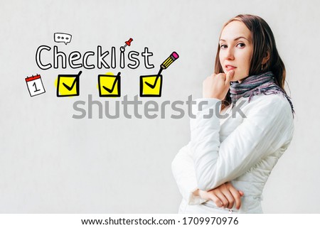 Checklist concept - girl on a white background with icons and text. Close up.