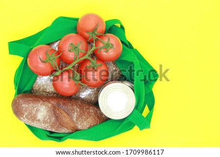 Food supply. Crisis stocks for the period of quarantine isolation on a yellow background. Tomatoes, buckwheat, lentils, bread, canned food, cereals, food delivery, coronavirus quarantine. Copyspace.