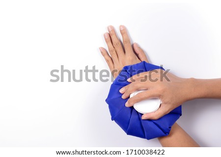 Man hand holding ice bag compress to the Wrist, Reduces pain and swelling of the muscles,isolated on white background