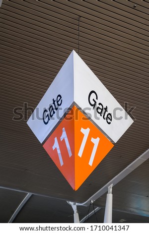 Aiport fight departure big gate sign in orange colors