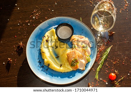mashed potatoes with fish on a plate