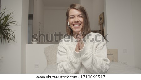 Smiling young caucasian woman blogger vlogger influencer sit at home speaking looking at camera talking make video chat, conference call record lifestyle blog vlog, webcam view Royalty-Free Stock Photo #1710069517