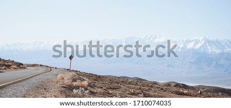 A traffic sign with the background of rolling mountains