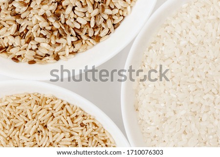 Bowl with different types of raw rice: brown, red, white, glutinous. The most popular asian healthy food, top view