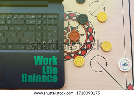 View from above of a smart phone with media icon and media list on the laptop keyboard.  Work from home and work life balance concept