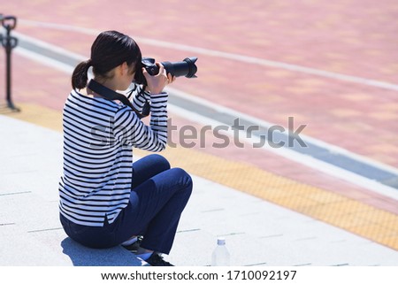 Japanese photographer shooting picture on campus
