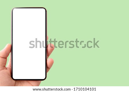 Mockup image of mobile phone with blank white screen  isolated on green background to do list and office notice or information board with appointment notes