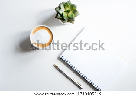 Empty notebook succulent flowers, cup of coffee. Mockup notepad on white background. Still life. Spring romantic mood. Colorful lightTop view. Copy space