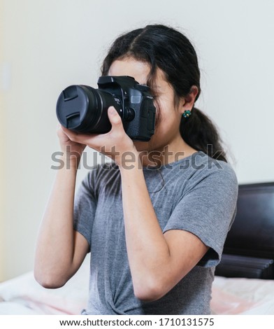 young woman take a picture with a digital camera 
