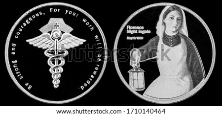 Florence Nightingale, commemorative material silver coin on black background Royalty-Free Stock Photo #1710140464