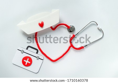 Stethoscope forming heart with its cord. Thank you doctor and Nurses and medical personnel team. Healthcare concept. Space for text. Soft focus. Top view.