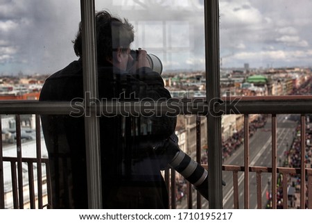 Photographer taking picture landmark the european city from a high view point. Travel photos concept.