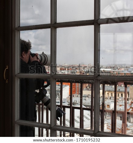 Photographer taking picture landmark the european city from a high view point. Travel photos concept.