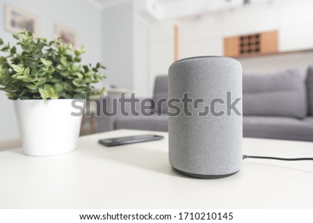 Smart speaker device in living room. Intelligent assistant in smart home system. Royalty-Free Stock Photo #1710210145