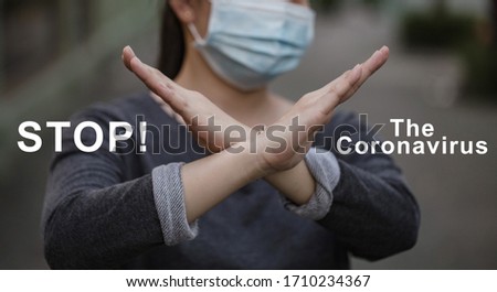 Women wearing Mask cross her arms in front of her with text says "STOP! The Coronavirus"
in the situation of Virus outbreak.