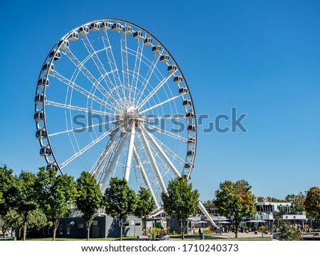 Giant ferris wheel with blue sky background and copy space.