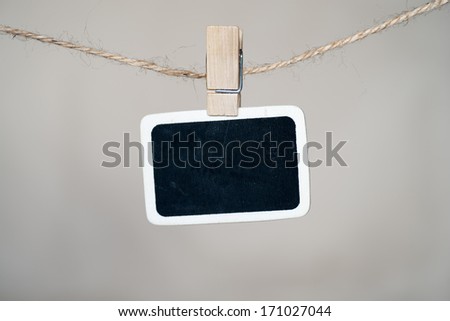 Close up of an old photo and clothes peg on a wall background