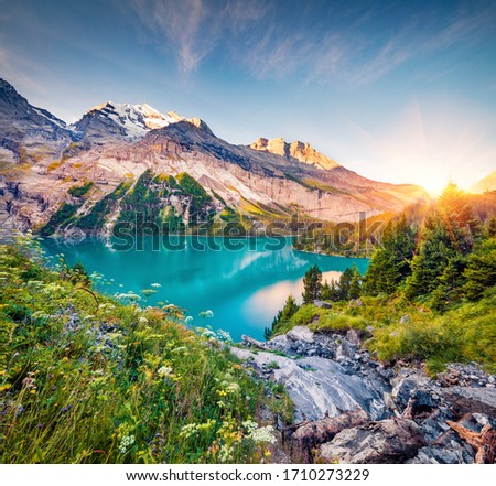 Exciting morning view of unique Oeschinensee Lake. Colorful summer sunrise in Swiss Alps with Bluemlisalp mountain, Kandersteg village location, Switzerland, Europe. Royalty-Free Stock Photo #1710273229