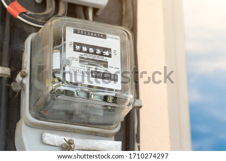 Electric meter with blue sky and sun light. Watt hour meter with copy space. Electric  equipment for measure power usage. Royalty-Free Stock Photo #1710274297