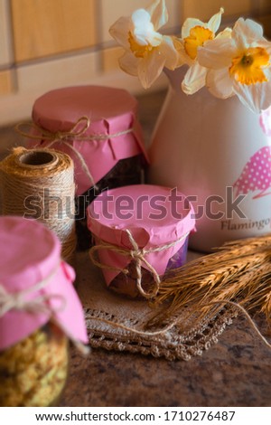 Fragrant dried herbs on a background of a white jug with flowers