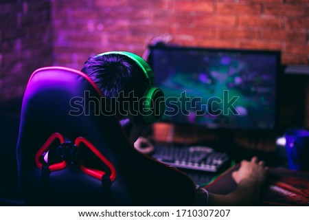 computer games, playing place, young gamer playing video games with headphones