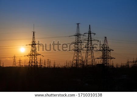grid high voltage power lines. High voltage tower sky sunset background Royalty-Free Stock Photo #1710310138