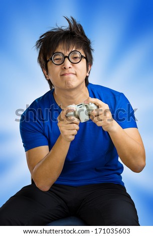 Man playing video game over blue background