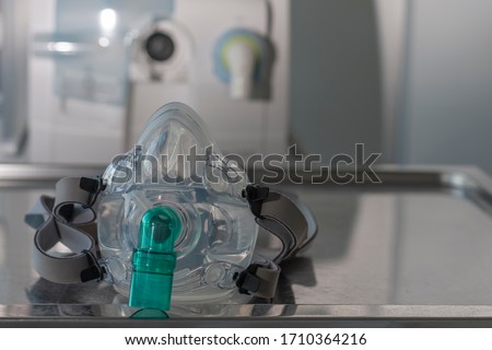 Non-invasive ventilation face mask, on background medical ventilator in ICU in hospital.  Royalty-Free Stock Photo #1710364216