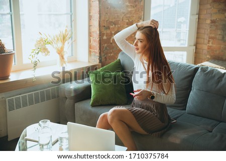 Caucasian woman singing during online concert at home isolated and quarantined. Using camera, laptop, streaming, recording courses, dancing. Concept of art, support, music, hobby, education.