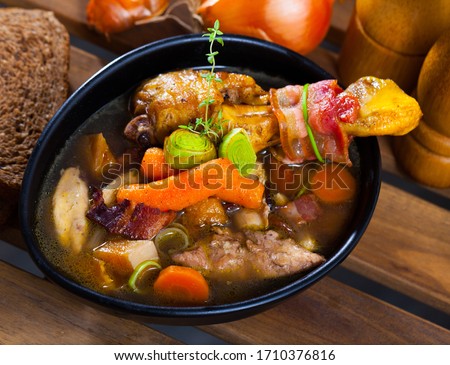 Scottish cuisine. Traditional chicken soup dish Cock-a-leekie with leeks in black plate

 Royalty-Free Stock Photo #1710376816