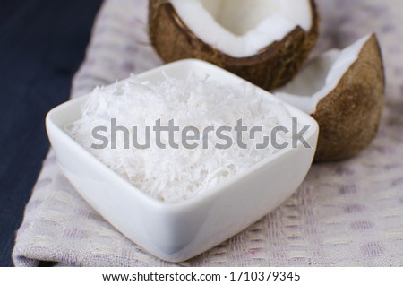 Coconut, coconut shavings and coconut milk on a black background. 