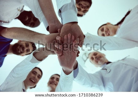 Close up of doctors team joining hands as symbol of unity stock photo Royalty-Free Stock Photo #1710386239