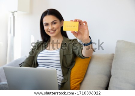 Smiling lady demonstrating plastic credit card stock photo. Online shopping concept