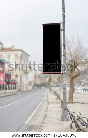 Blank billboard mock up, public information board with copy space on the street. Empty flag banner for your advertising, clear poster in city with beautiful background (boats, yachts in pier) 