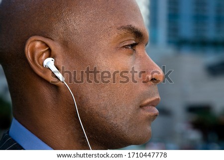 Profile view of a businessman wearing headphones