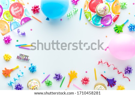 A top down view of common birthday party items in a border frame.