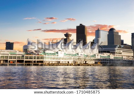 Canada Place and commercial buildings in Downtown Vancouver Viewed from water during sunset. British Columbia, Canada.