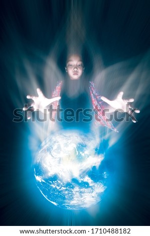 Save of the world, environment concept. Beautiful planets world and Fantastic little asian boy stretching out his hands on black background. Elements of this image furnished by NASA.