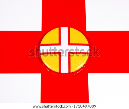 A badge portraying the flag of the English county of Dorset, pictured over the England flag.