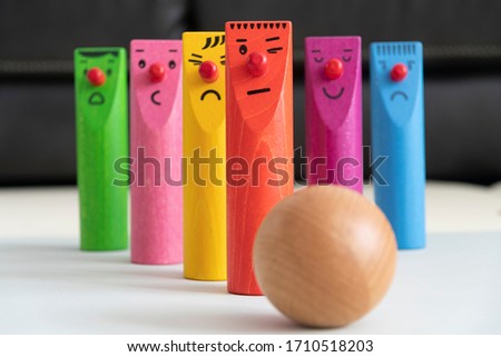 Colorful wooden bowling pins with a ball