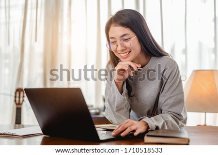 Woman work from home have a coffee cup beside wait epidemic situation to improve soon at home. Coronavirus, covid-19, Work from home (WFH), Social distancing, Quarantine, Prevent infection concept. Royalty-Free Stock Photo #1710518533