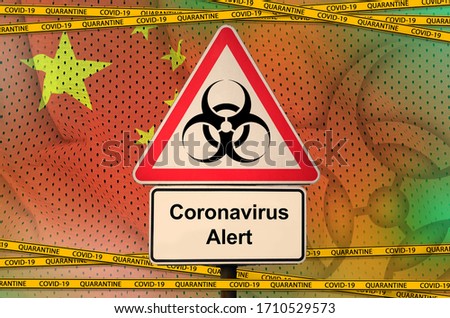 China flag and Covid-19 biohazard symbol with quarantine orange tape. Coronavirus or 2019-nCov virus concept