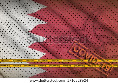 Bahrain flag and orange Covid-19 stamp with border tape. Coronavirus or 2019-nCov virus concept
