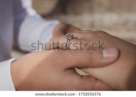 engagement rings during proposal, groom and bride hands
