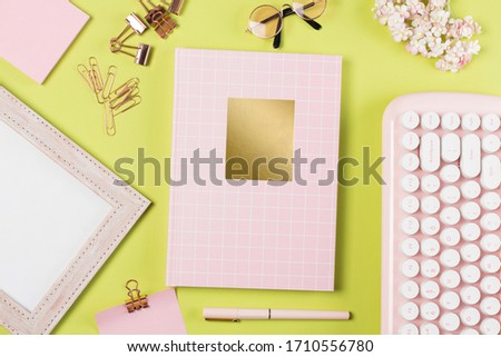 flat lay stationery on work desk in green pastel background