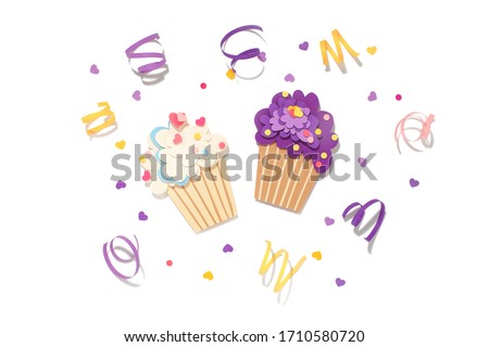 Two paper cutting cupcake on isolated background. Handmade art work. Colorful sprinkles (dot and star) for your birthday card design. Confetti. Holiday inspiration. 