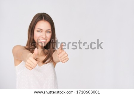Girl show thumb up. Approve gesture. Young woman studio pretty portrait. Happy yes sign. Female person satisfied winner.