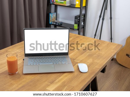 Remotely working at home office in your room.A laptop computer with media editing software  place on the table.You can create your workplace at your house by internet technology.Freelance workspace.